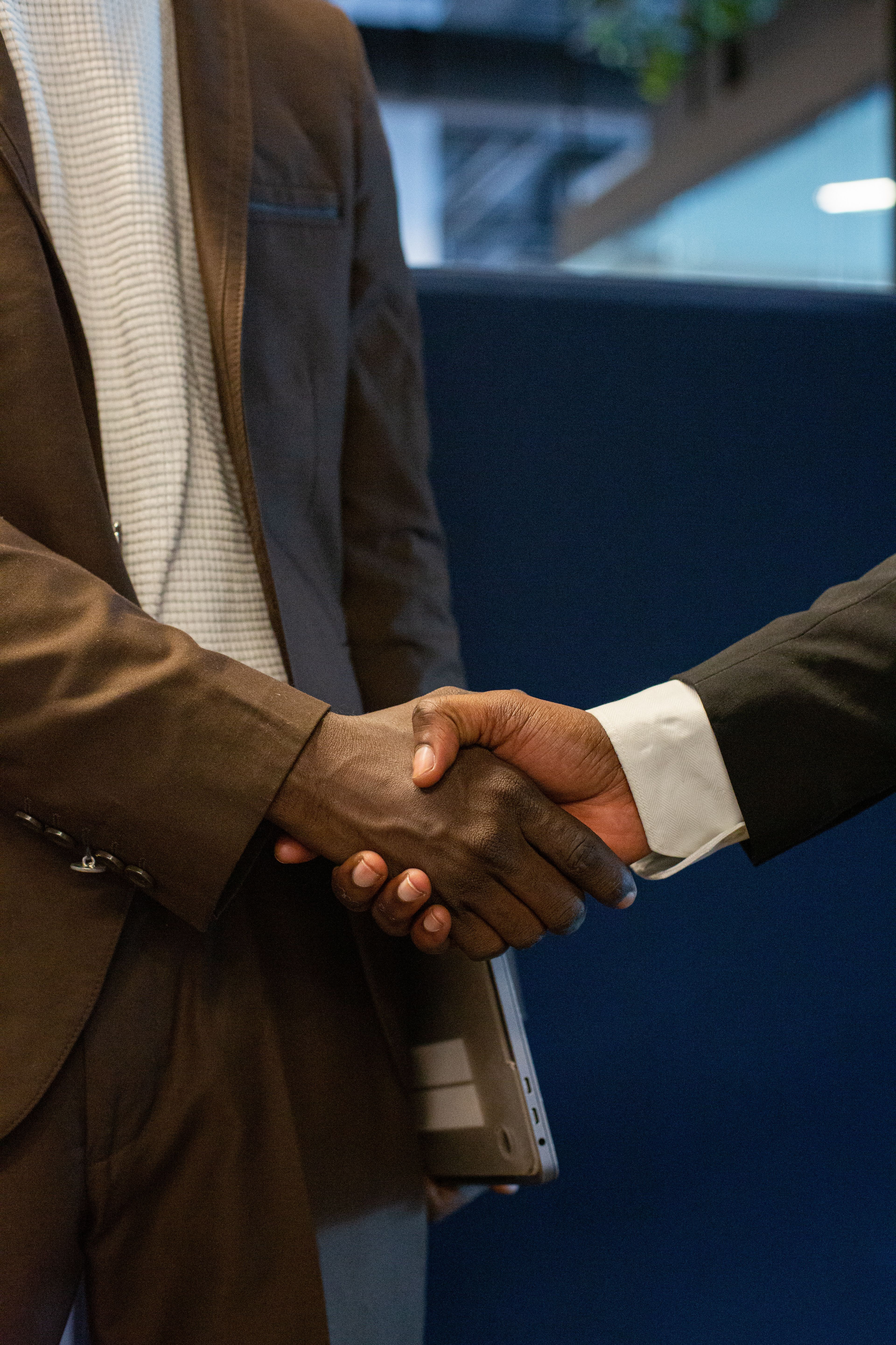 Two business specialists shaking hands to confirm a reliable platform launch.